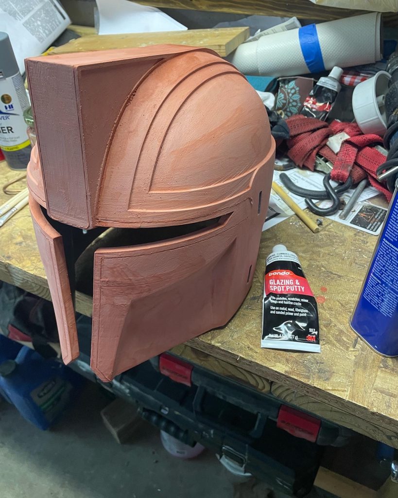 The Architect mando helmet with 3 coats of filler ready to be sanded.